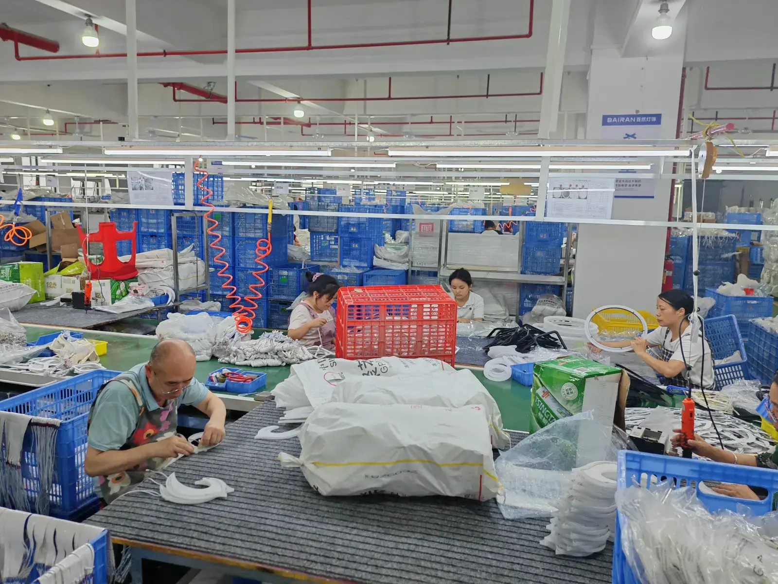 Specialists assembling acrylic LED chandeliers