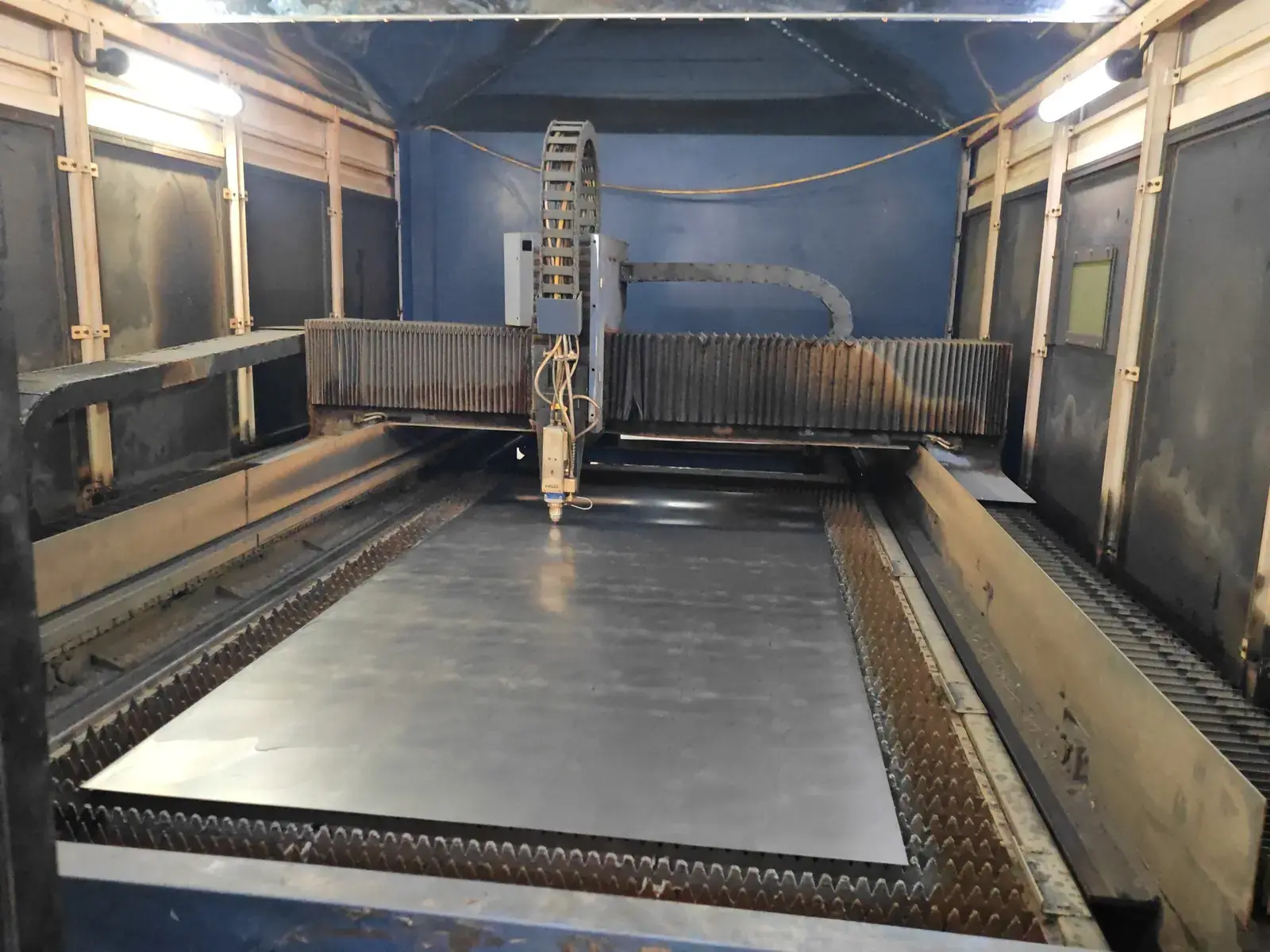 Laser cutting machine processing a metal sheet