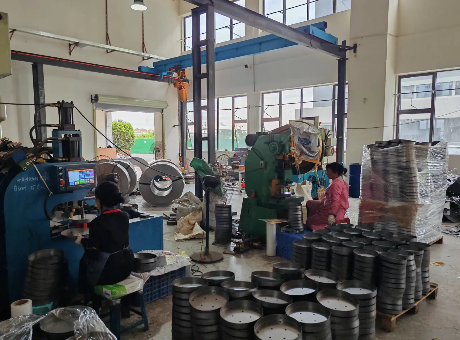 Metal lighting components being formed and prepared in the workshop